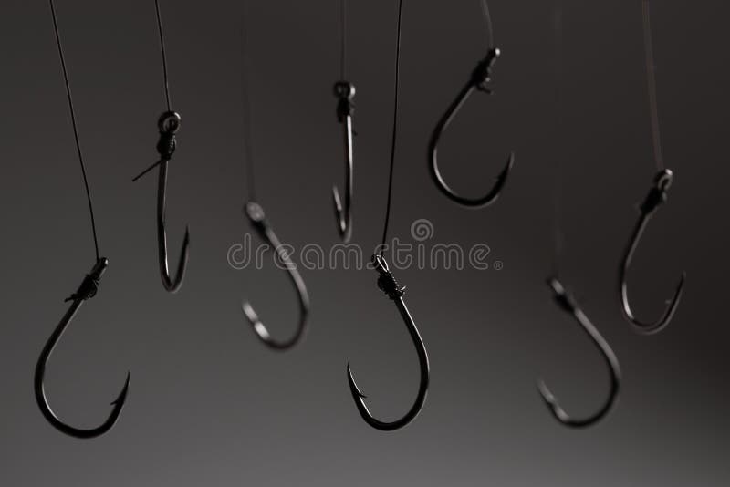 Fishing Hooks Hanging on a Fishing Line on a Grey Background Stock