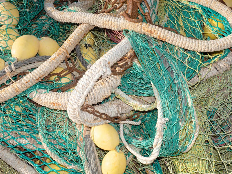 https://thumbs.dreamstime.com/b/fishing-net-drying-port-green-net-yellow-buoys-rusty-chain-fishing-net-drying-port-green-net-190599785.jpg