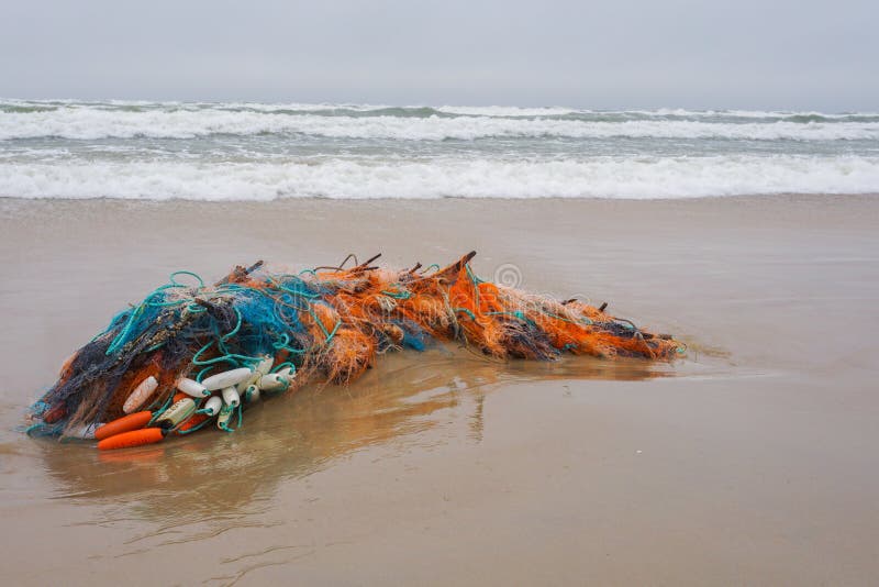 Fishing Nets on a Sand after Sea Storm. Environmental Pollution. Stock