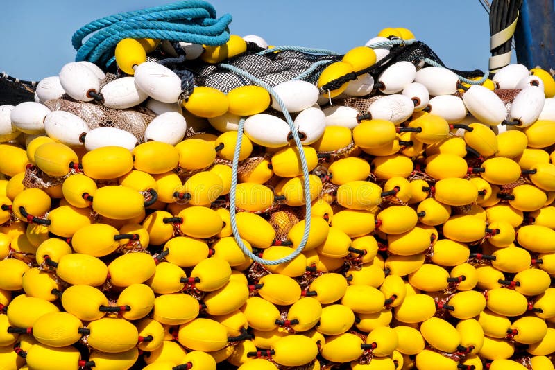 Fishing nets with yellow floats on the pile, close up
