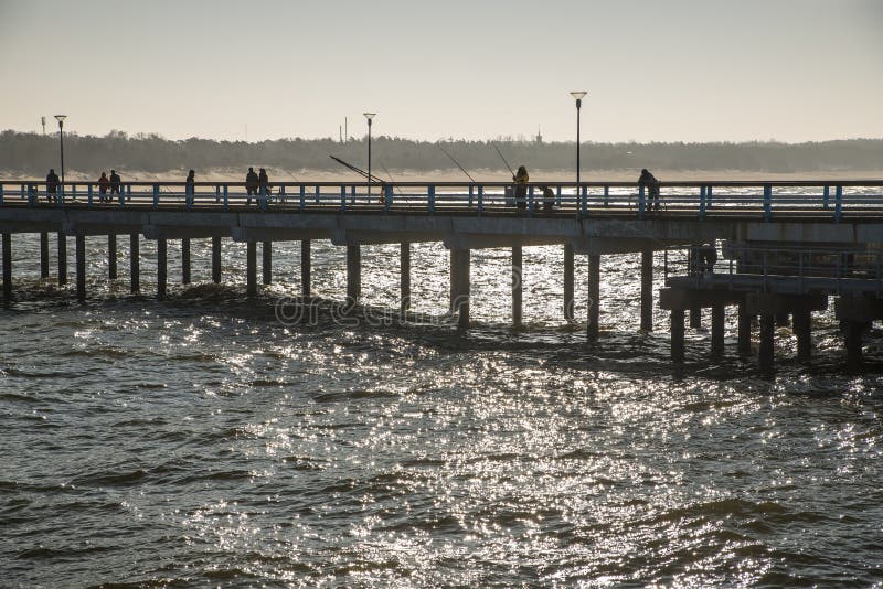 View of fishing pier silhouette in the Baltic sea. Boardwalk rail stock images, royalty-free photos and pictures