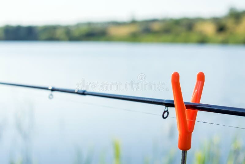 Fishing Rod Feeder Stands on the Orange Holder. Comfortable Fish