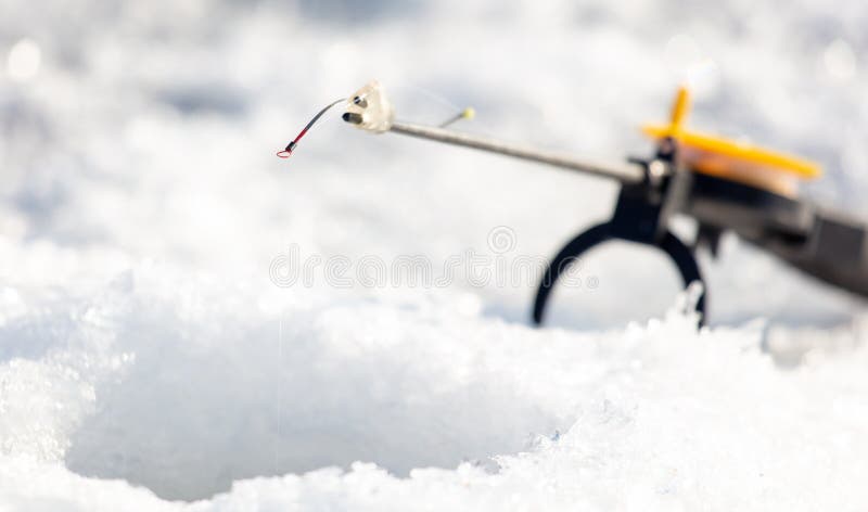 Fishing rod on ice in winter. Ice fishing stock image