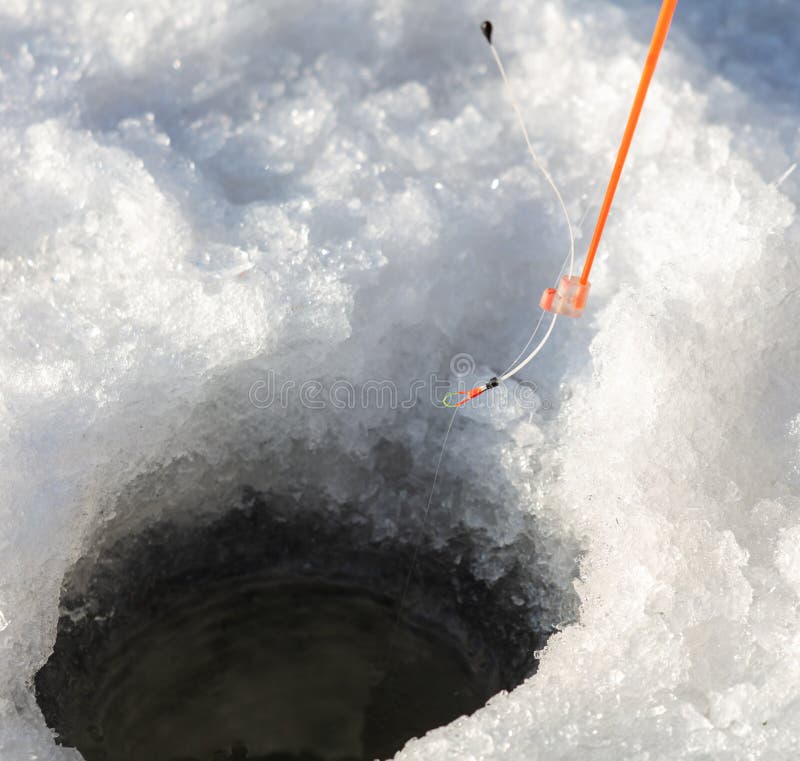 Fishing rod on ice in winter. Ice fishing stock photos