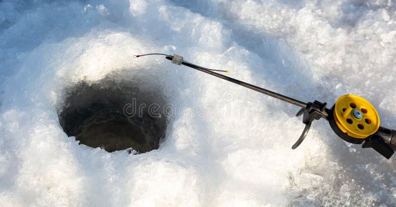 Fishing rod on ice in winter. Ice fishing stock photography