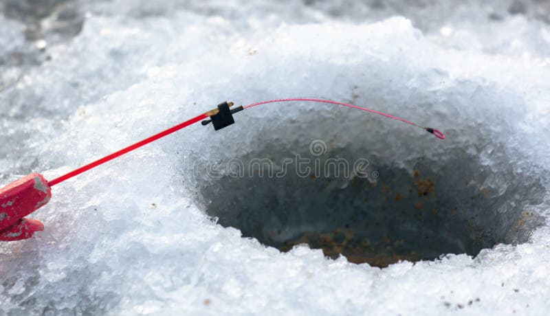 Fishing rod on ice in winter. Ice fishing stock images