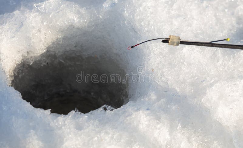 Fishing rod on ice in winter. Ice fishing royalty free stock photography