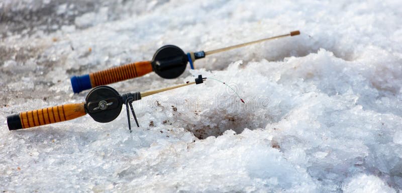 Fishing rod on ice in winter. Ice fishing stock photo