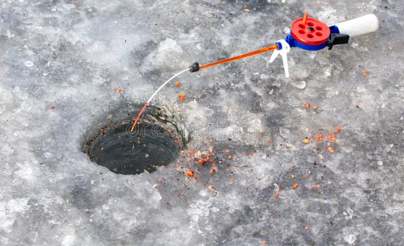 Fishing rod on ice in winter. Ice fishing stock photos