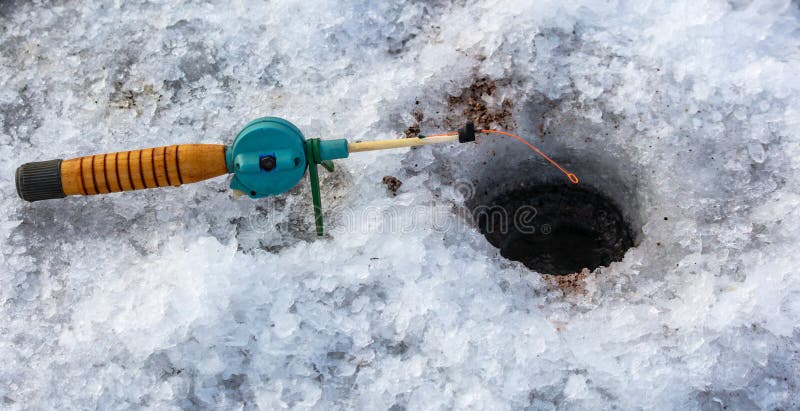 Fishing rod on ice in winter. Ice fishing royalty free stock photos