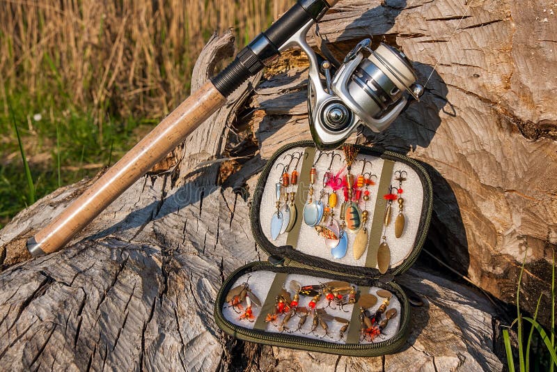 Fishing Rod With Reel And Various Kind Of Baits On The Natural B Stock