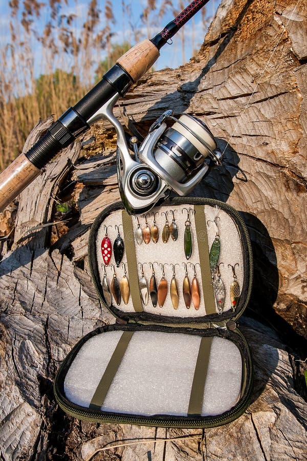 Fishing Rod With Reel And Various Kind Of Baits On The Natural B Stock