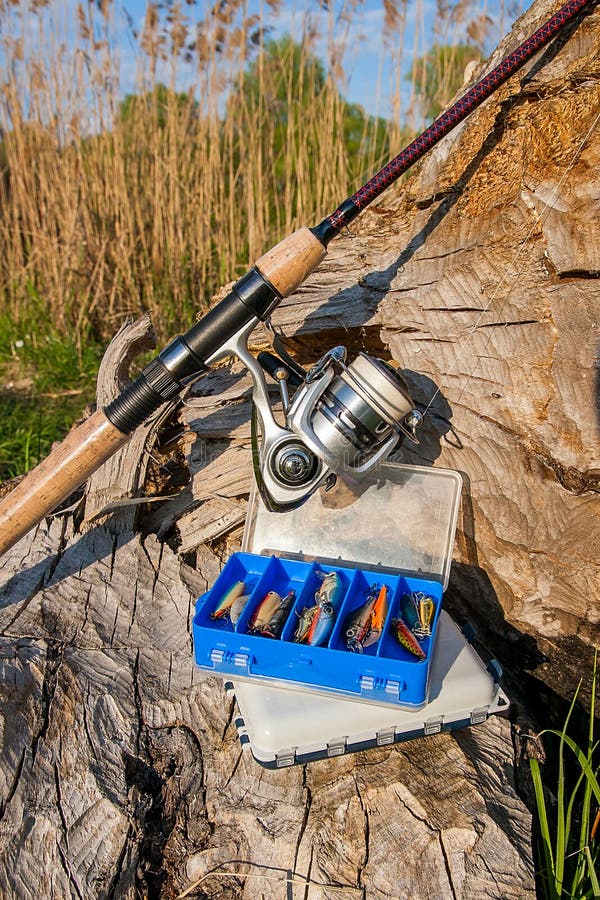 Fishing Rod With Reel And Various Kind Of Baits On The Natural B Stock