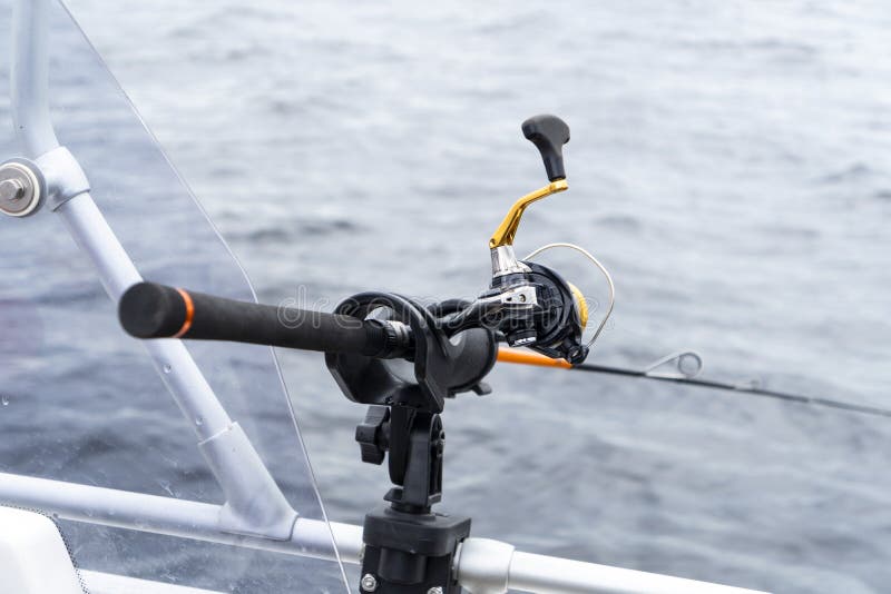 Fishing Rod Spinning with the Line Close-up. Fishing Rod in Rod Holder in Fishing  Boat. Fishing Rod Rings. Fishing Tackle Stock Photo - Image of hand, fish:  186322116