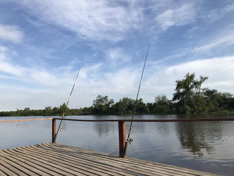 Fishing Rods on the River Bank Stock Photo - Image of blue, boat: 133950704