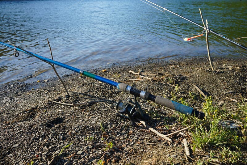 Fishing Rods and Fishing Tackle on the River Bank, Closeup Stock