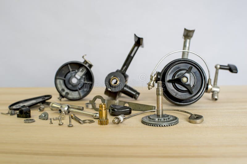 A Fishing Spinning Reel As a Whole and a Second Similar Completely  Disassembled. Concept: Parts of a Whole Stock Image - Image of metal,  assembly: 152923169