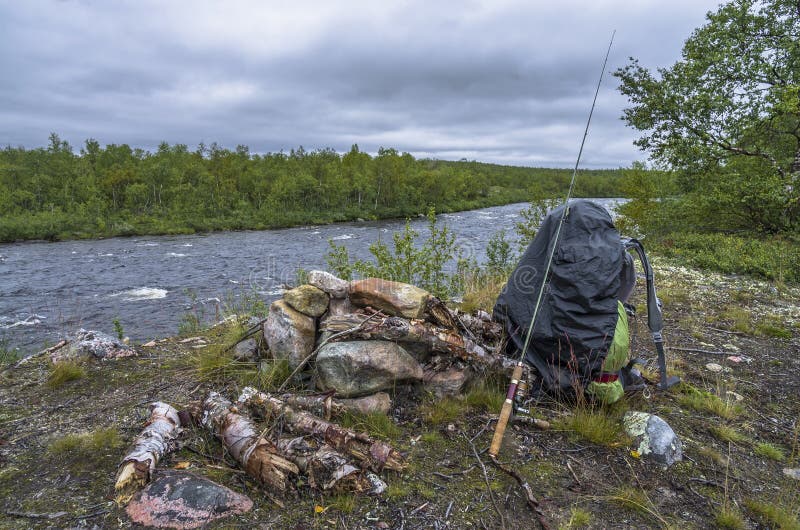 Fishing Trip. Backpack and Fishing Tackles on Wild River Shore Stock Photo Image of rock