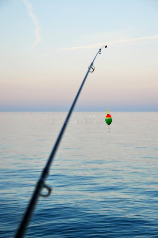 Fishing pole waiting to be cast, with line and sinker. Fishing pole waiting to be cast, with line and sinker