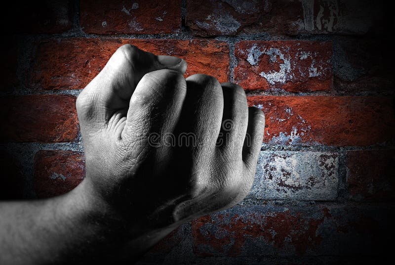 Fist against brick wall