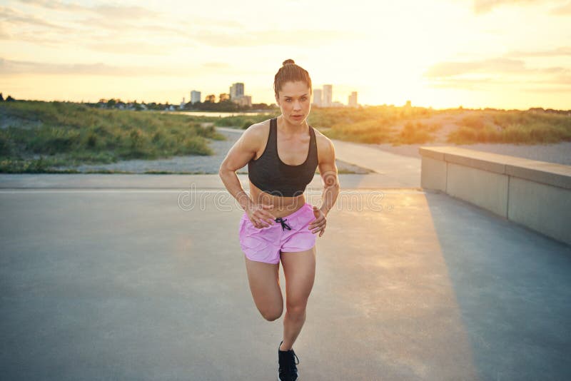 Fit determined young woman out jogging royalty free stock photos