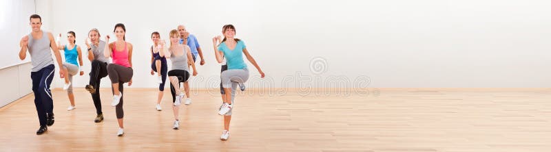 Fit Group Doing Aerobics Exercise At Class royalty free stock images