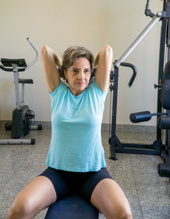 Fit Lady 50 plus doing triceps exercises.