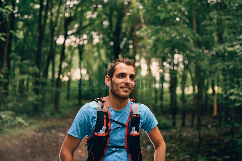 Fit male jogger rests during day jogging for cross country forest trail race in a nature park. royalty free stock photo Fit male jogger rests during day jogging for cross country forest trail race in a nature park. royalty free stock photo