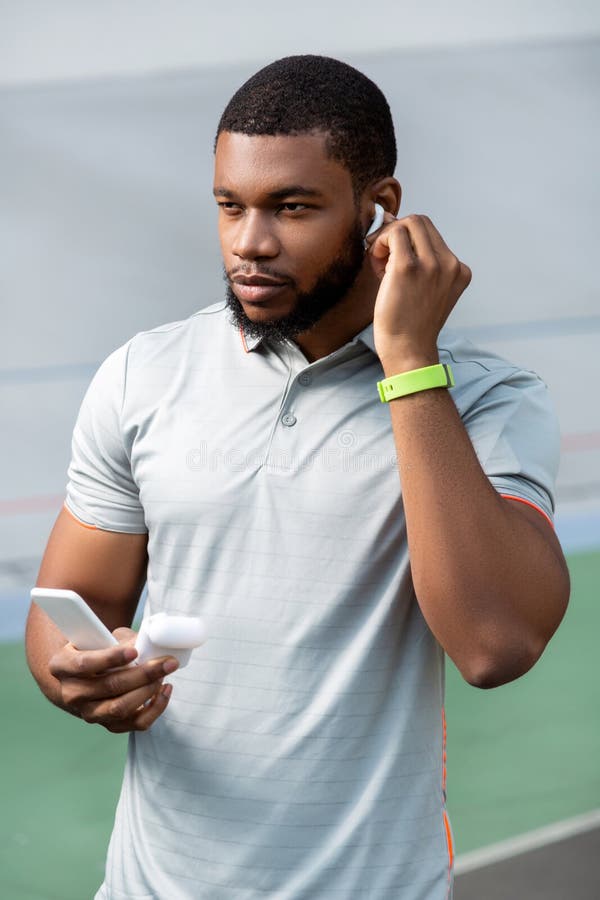 Fit Man with Wireless Earphones and a Smartphone Stock Image - Image of ...