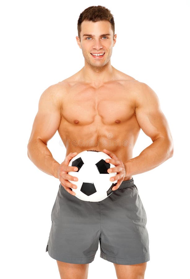 Fit muscular man with soccer ball on white