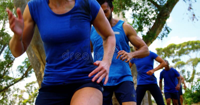 Fit people practicing tire obstacle course training 4k