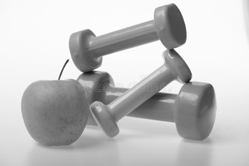 Apple fruit and pink, green and blue barbells stock photos Apple fruit and pink, green and blue barbells stock photos