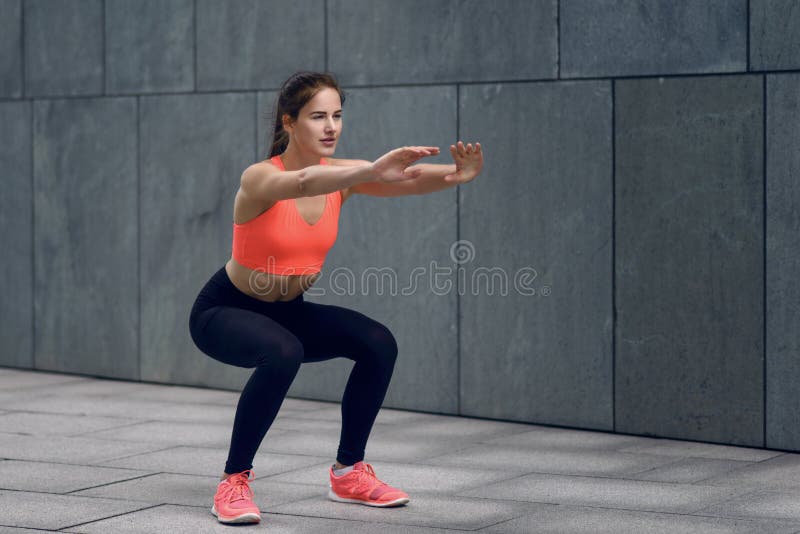 Fit young woman doing squats stock photos Fit young woman doing squats stock photos