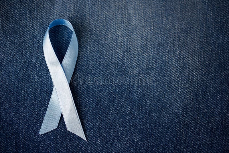 Medicine, health care and symbolics concept - close up of blue prostate cancer awareness ribbon. Medicine, health care and symbolics concept - close up of blue prostate cancer awareness ribbon