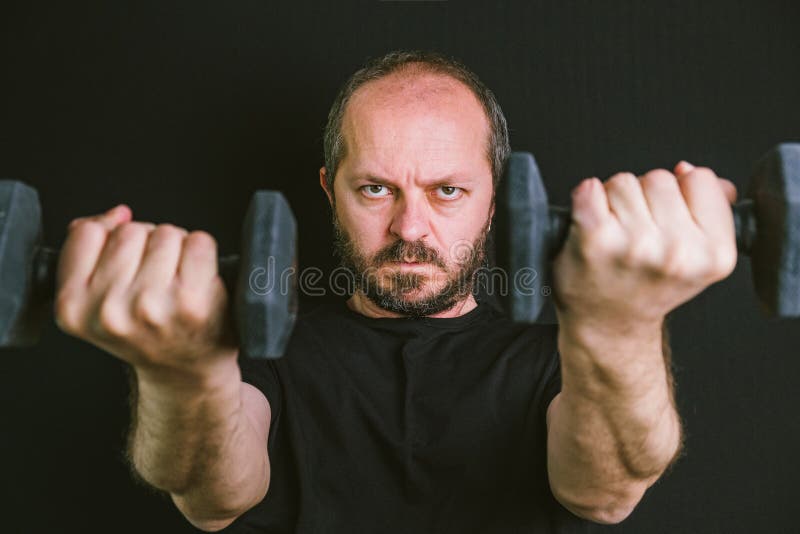 Adult Man Training Muscles At Home Gym Doing Biceps With Dumbbell