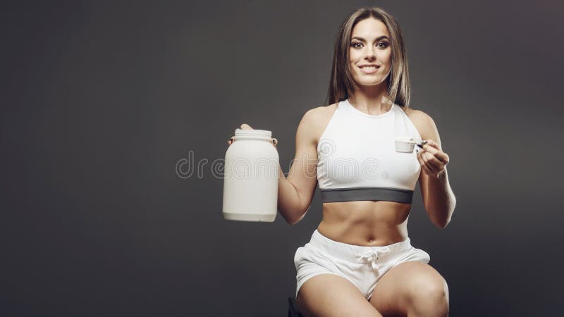 Young Adult Woman In 30s Using Protein Shaker And Baby Food Bottle