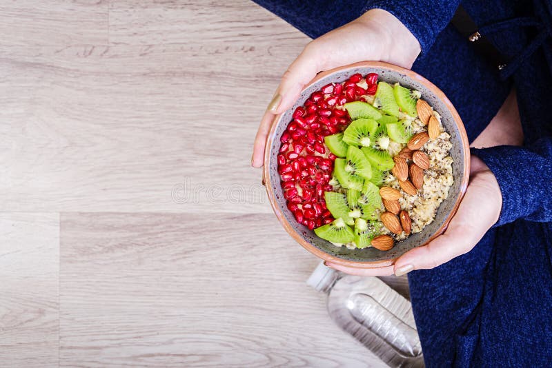 Fitness and healthy lifestyle concept. Female is resting and eating a healthy oatmeal after a workout. stock photography Fitness and healthy lifestyle concept. Female is resting and eating a healthy oatmeal after a workout. stock photography