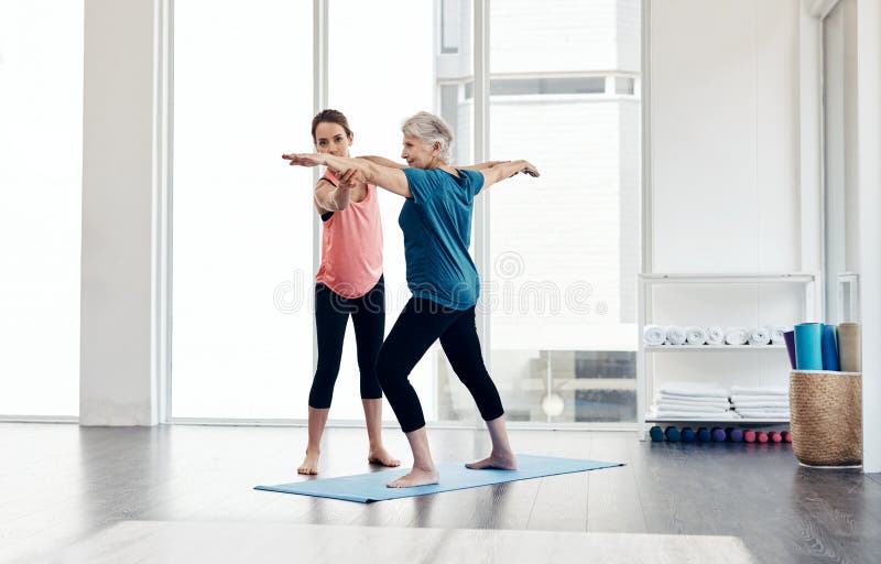 Fitness Leads To A Better Quality Of Life A Fitness Instructor Helping A Senior Woman During A