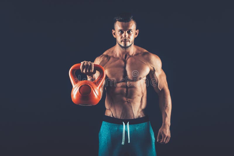 Fitness man doing a weight training by lifting heavy kettlebell stock images Fitness man doing a weight training by lifting heavy kettlebell stock images