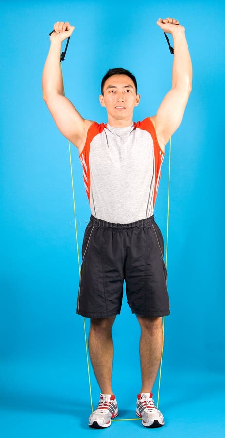 Fitness man use tubing to strengthen