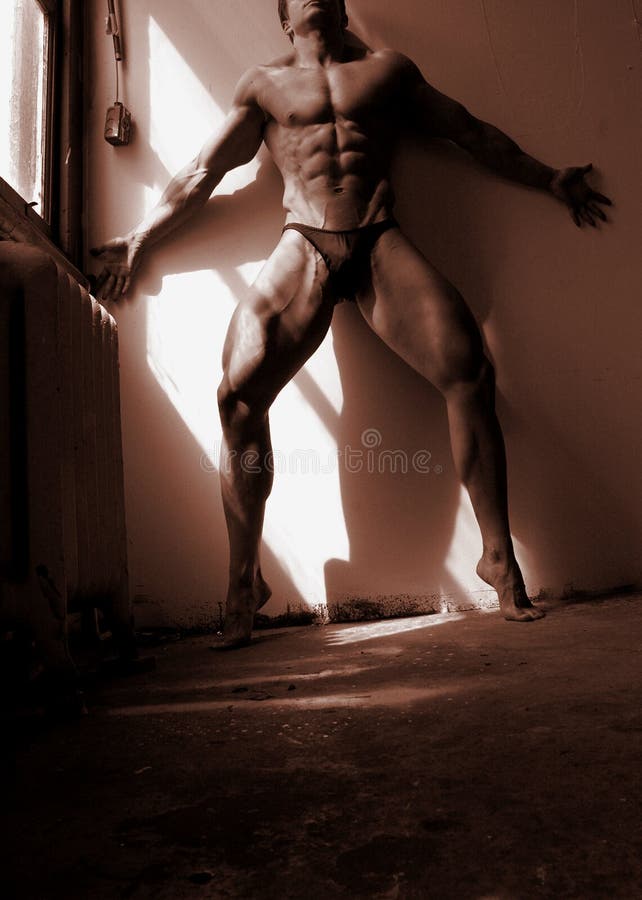 Fitness model in a shaft of light royalty free stock image Fitness model in a shaft of light royalty free stock image