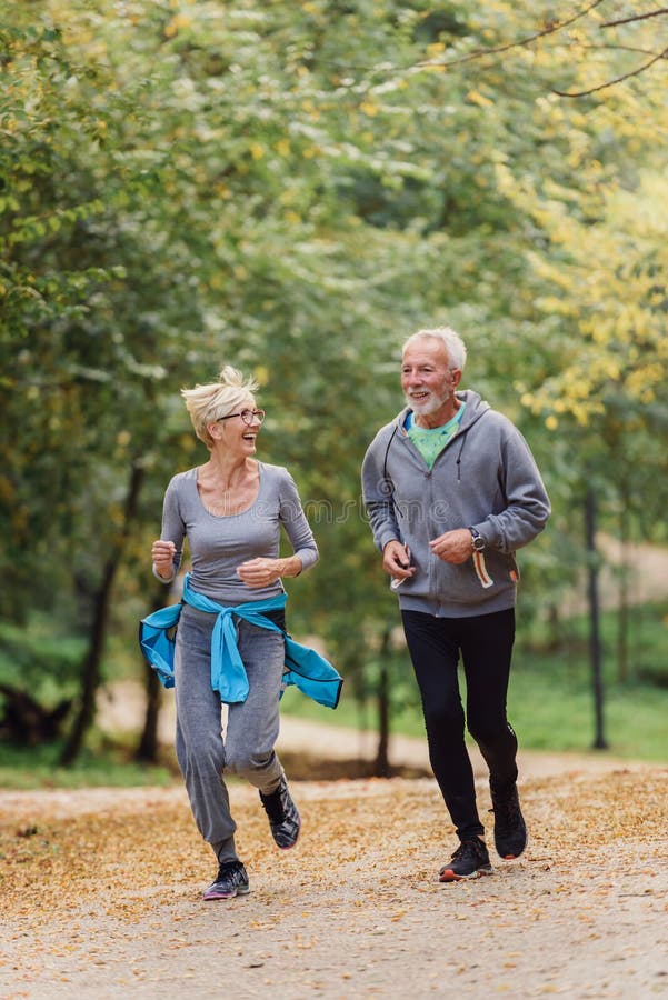 Cheerful Active Senior Couple Jogging in the Park Stock Photo - Image ...