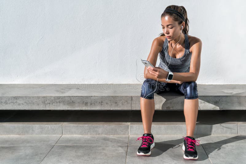 Fitness runner girl using music mobile phone app