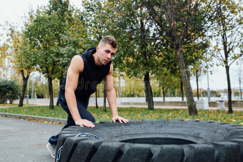 Fitness sport man workout outdoor. with tractor tire. stock images Fitness sport man workout outdoor. with tractor tire. stock images