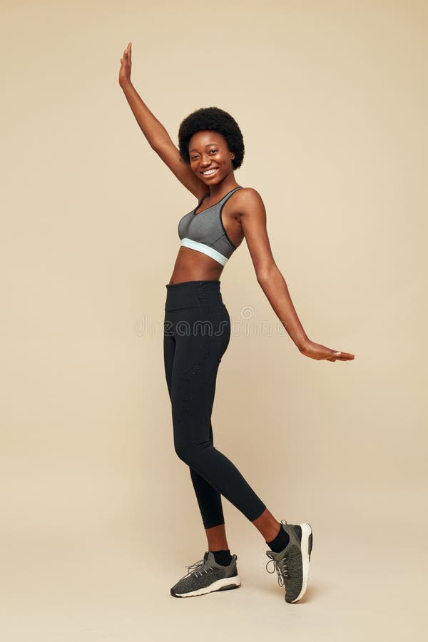 Fitness. Sporty African Woman Full-Length Portrait. Smiling Female In Sportswear Holding Hand Up And Looking At Camera.