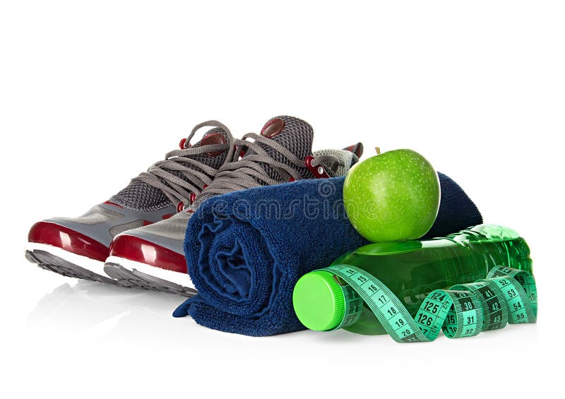 Fitness, weight loss concept with sneakers, green apples, bottle of drinking water and tape measure royalty free stock photos Fitness, weight loss concept with sneakers, green apples, bottle of drinking water and tape measure royalty free stock photos