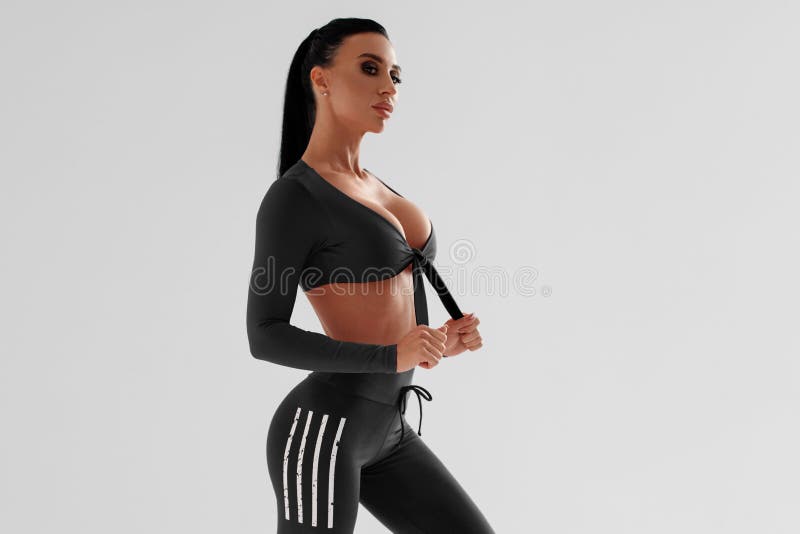 Fitness Woman In Leggings On Gray Background. Athletic Girl With Beautiful  Butt Stock Photo, Picture and Royalty Free Image. Image 137241805.