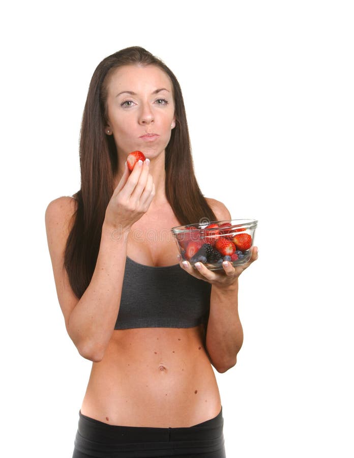 Fitness woman eating fresh fruit