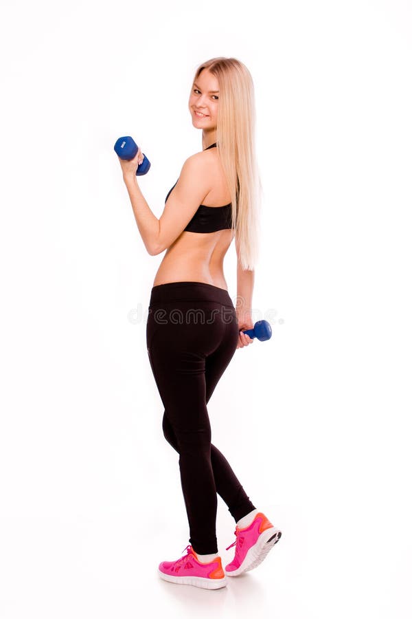 Fitness woman holding dumbbells portrait isolated on white backg. Photography of Fitness woman holding dumbbells portrait isolated on white background. Smiling stock photo Fitness woman holding dumbbells portrait isolated on white backg. Photography of Fitness woman holding dumbbells portrait isolated on white background. Smiling stock photo