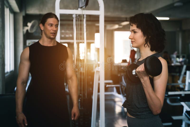 Fitness woman with personal trainer at gym stock photos Fitness woman with personal trainer at gym stock photos